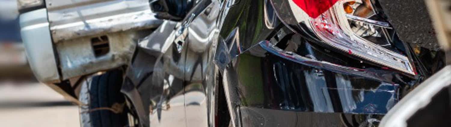 A damaged vehicle being documented after a collision